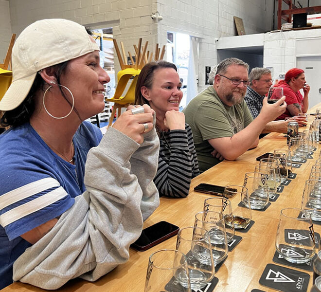 people at a beer tasting with glasses on table