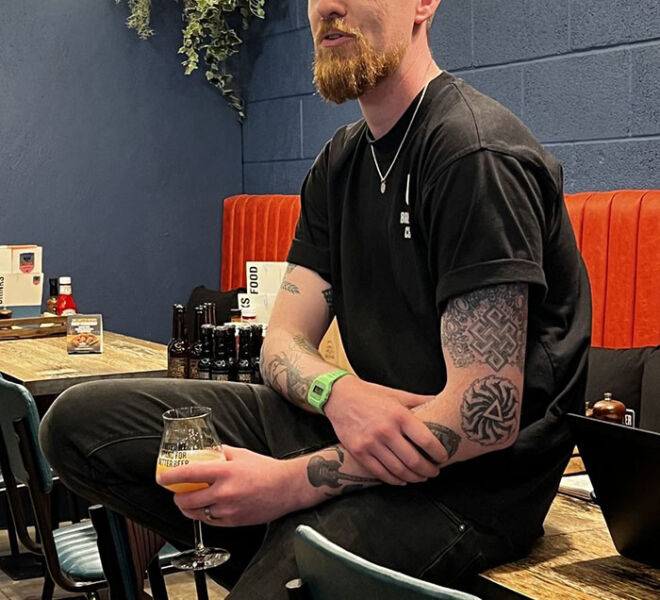 Male staff member at BrewDog sitting on table