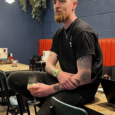 Male staff member at BrewDog sitting on table