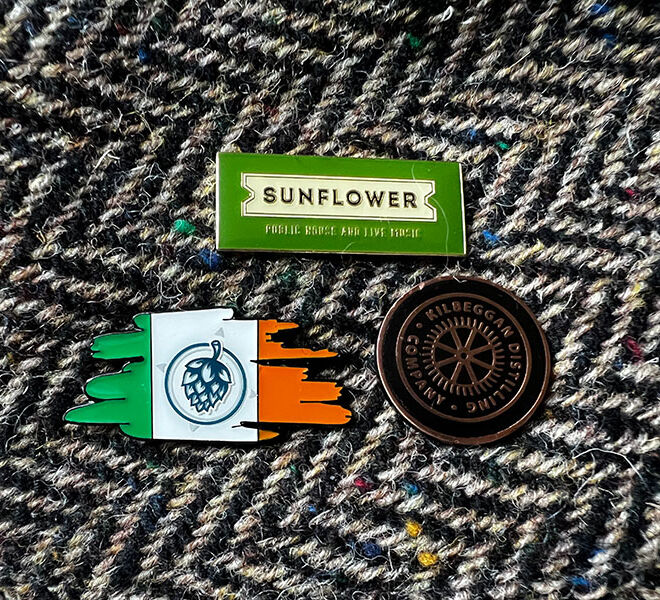 Enamel Pins on hat featuring Ireland logo with hop