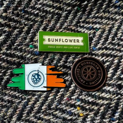 Enamel Pins on hat featuring Ireland logo with hop