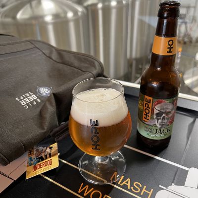 beer at hope brewing in ireland with beer tanks in background