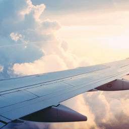 photo of an airplane wing out the window while in flight