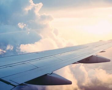 photo of an airplane wing out the window while in flight