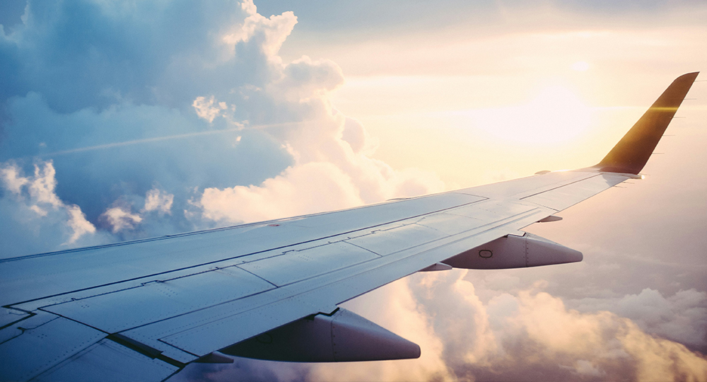 photo of an airplane wing out the window while in flight