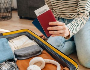 woman with passport packing for UK beer trip