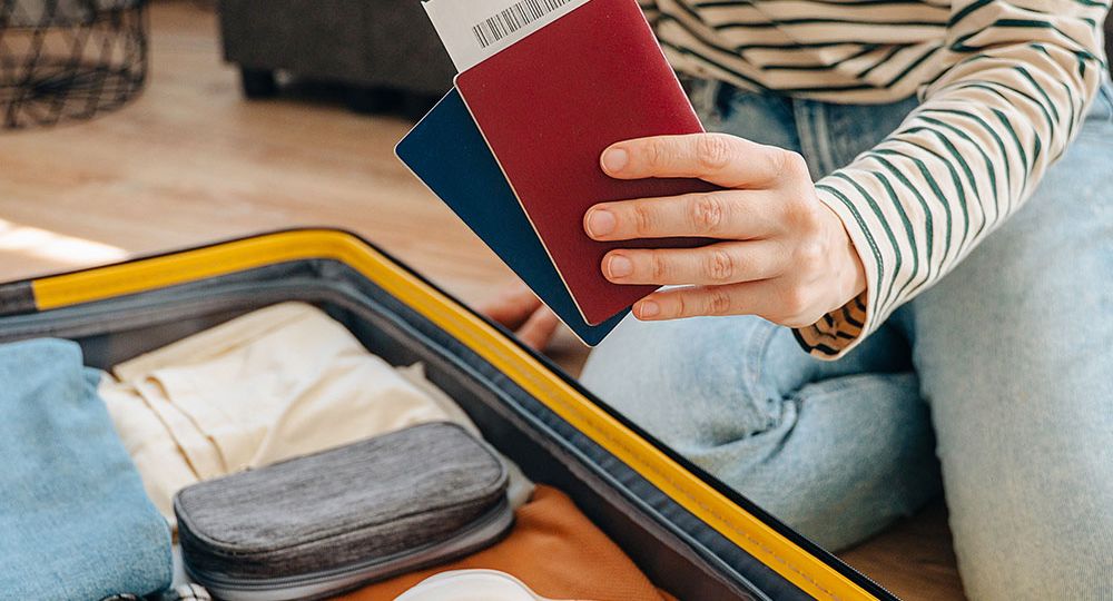 woman with passport packing for UK beer trip